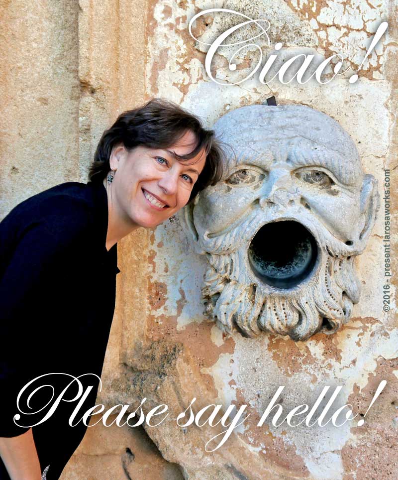 Karen La Rosa standing next to an ornate downspout outlet in Sicily.